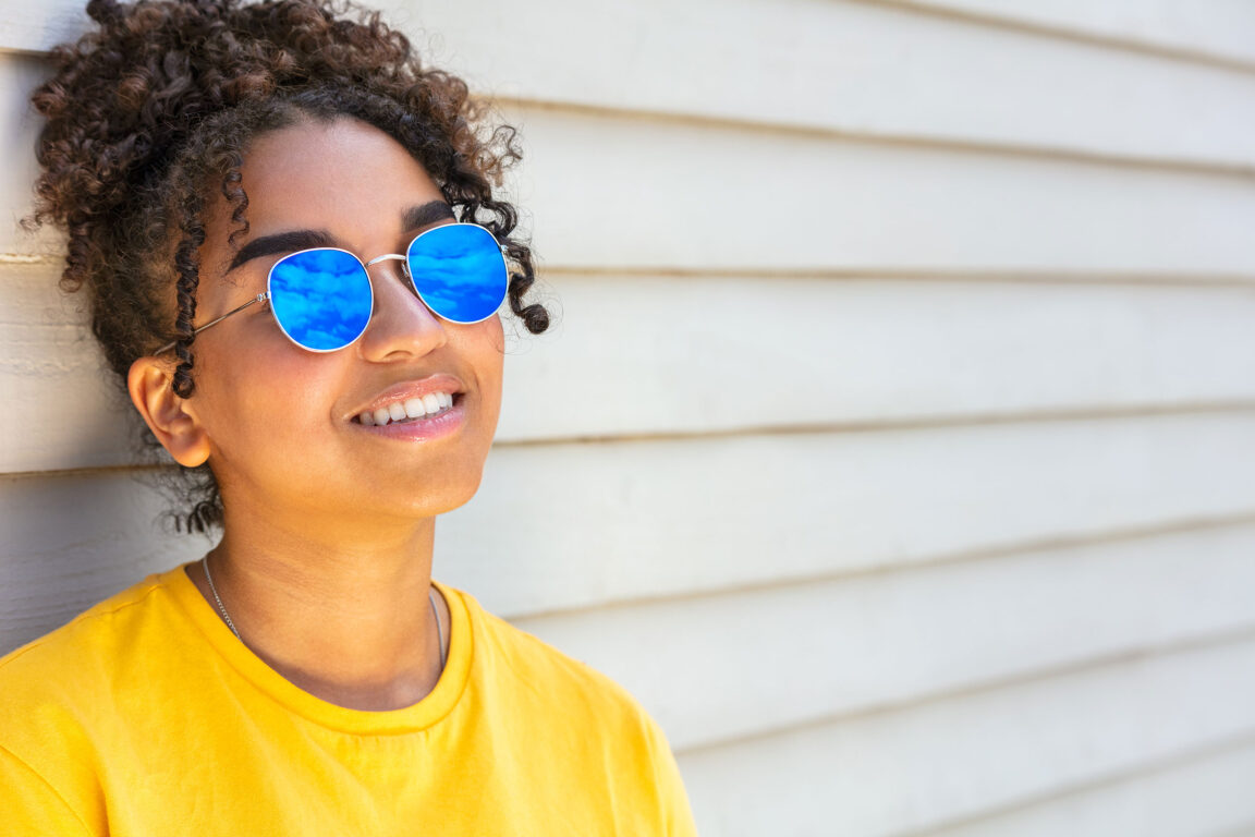 Girl wearing blue mirrored sunglasses